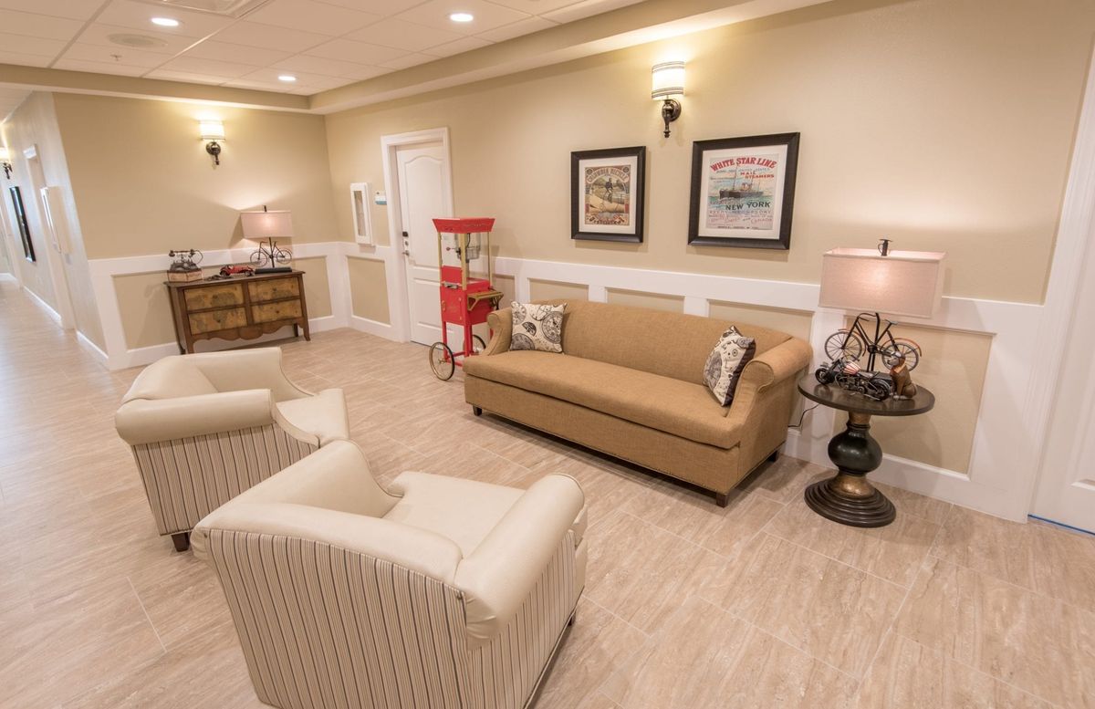 A cozy living room with elegant furniture and a popcorn machine.