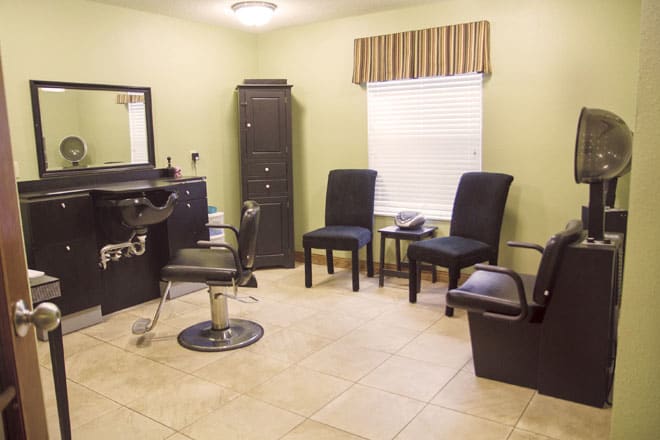 Cozy hair salon interior with a styling chair and seating area.