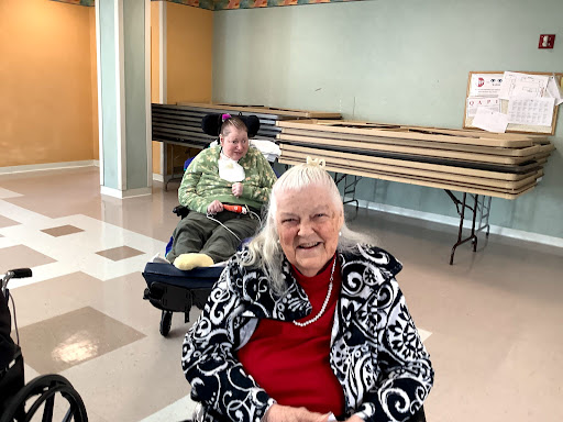 Two elderly women enjoying time together at a community center.