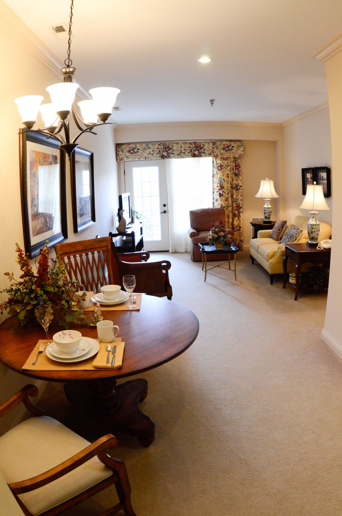 A cozy living and dining area featuring warm lighting and elegant furniture.