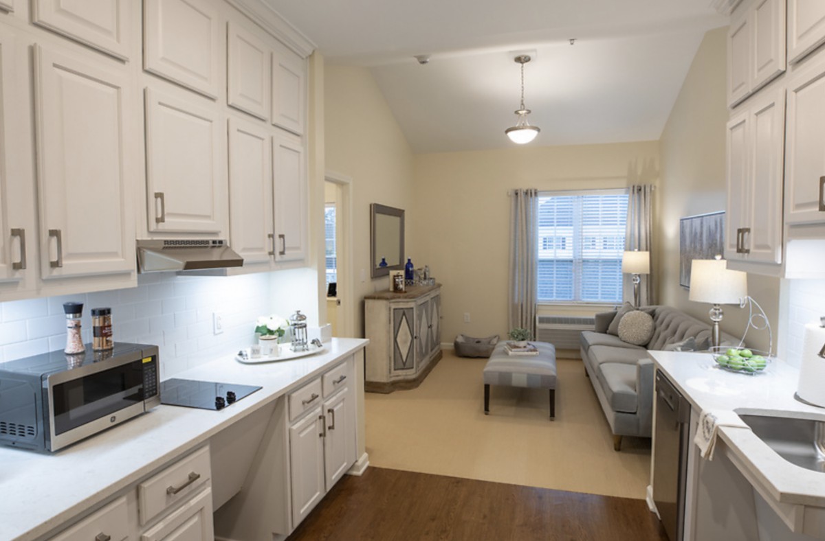 A modern open-layout kitchen and living area with stylish furnishings.