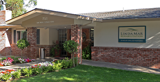 A charming residential home with a well-kept front yard and brick accents.