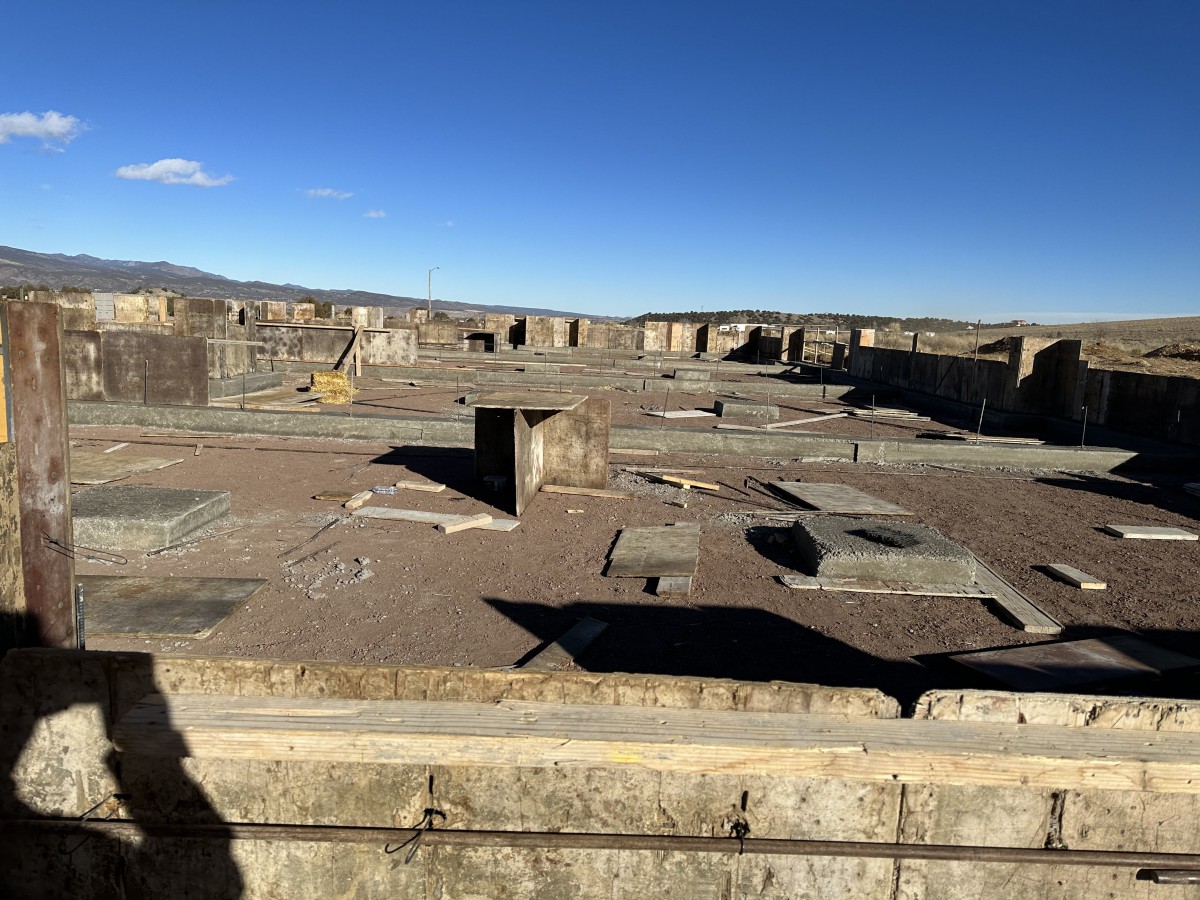 An expansive view of ancient stone ruins under a clear blue sky.