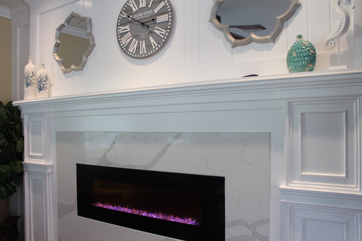 A modern interior with a sleek fireplace, decorative mirrors, and a stylish clock.
