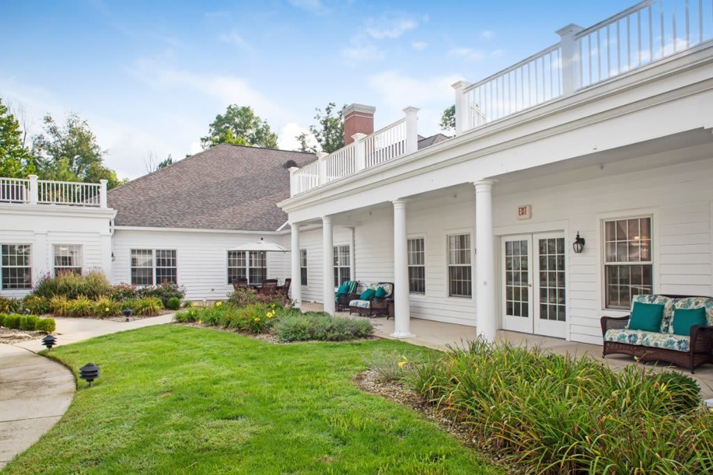 A beautiful house with a spacious lawn and garden area.