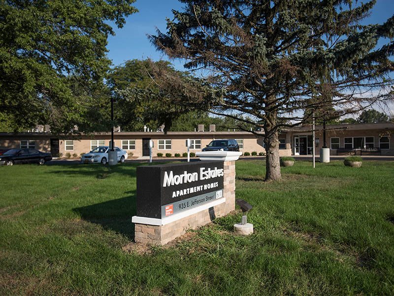 Entrance to Morton Estates Apartments with a prominent sign.