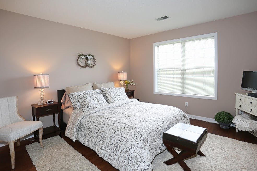 A cozy bedroom with stylish bedding and soft lighting.