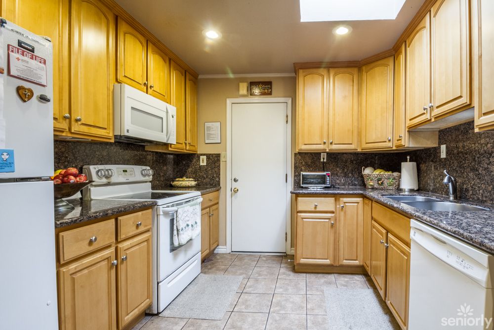 A cozy kitchen with wooden cabinets and modern appliances.