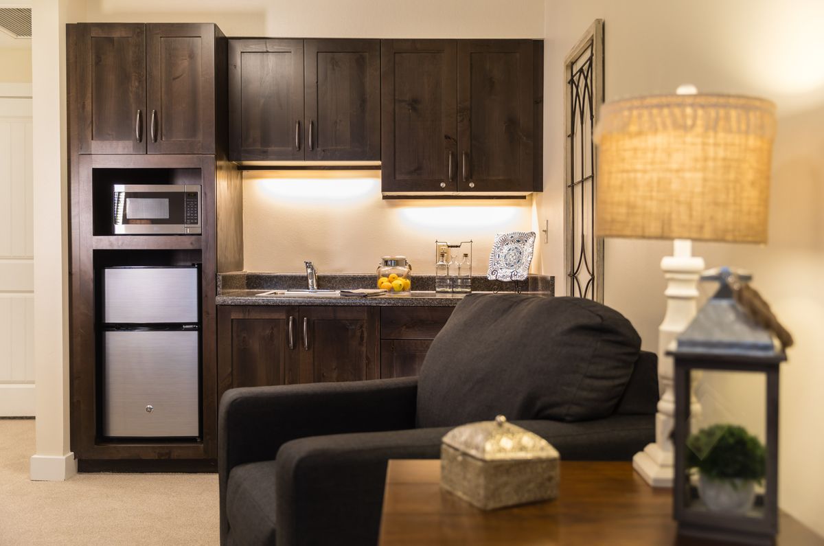 A cozy modern living space with a kitchenette and comfortable seating.