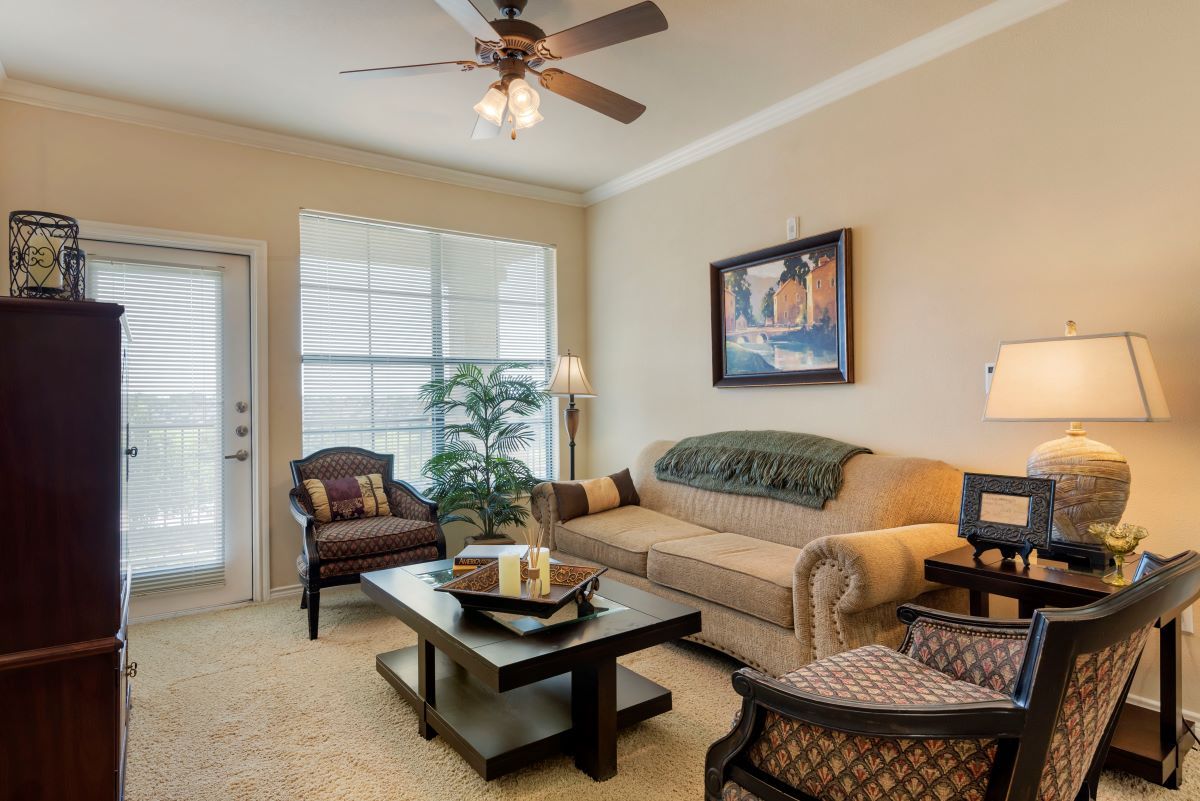 A cozy living room with a beige sofa, coffee table, and decorative elements.