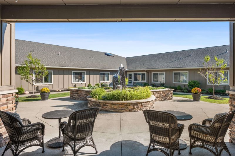 A tranquil courtyard with a central fountain, surrounded by seating and lush landscaping.