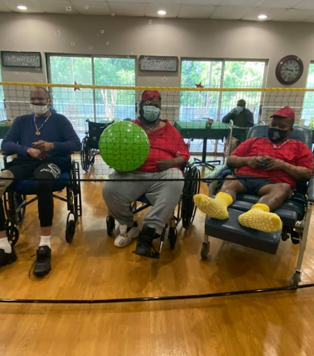 Seniors enjoying a recreational activity in a community center, engaging with each other while participating in a game.
