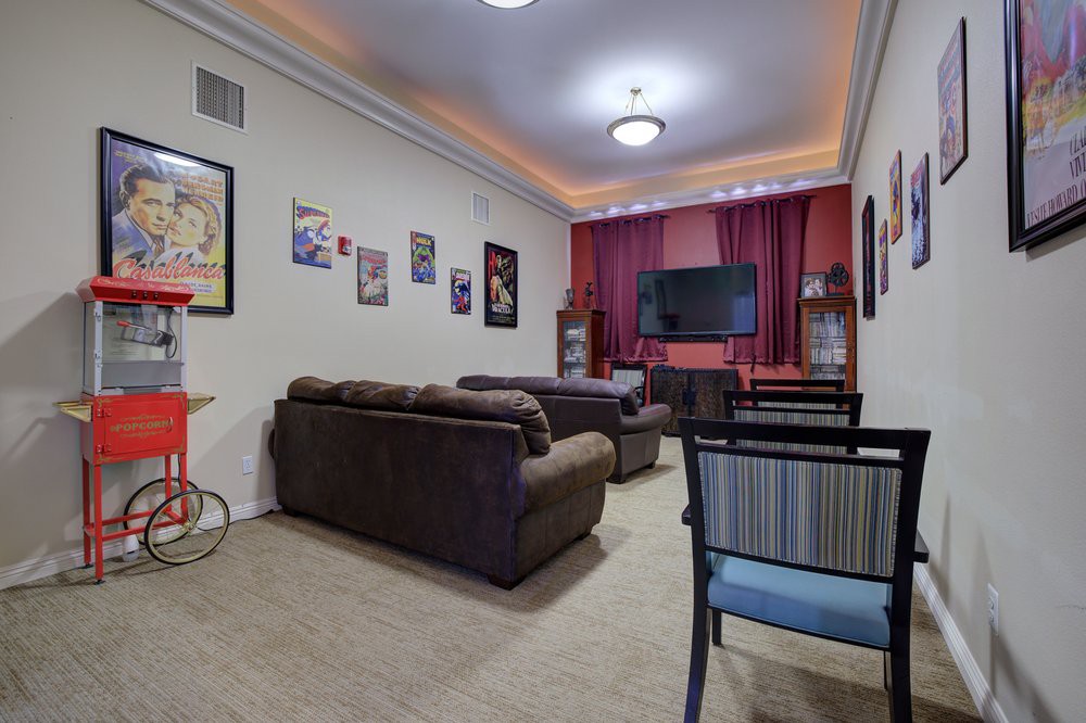 Cozy home theater with comfortable seating and a wall-mounted television.