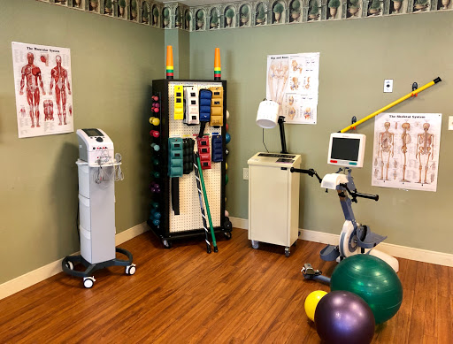 A well-equipped physical therapy room featuring various exercise tools and rehabilitation equipment.