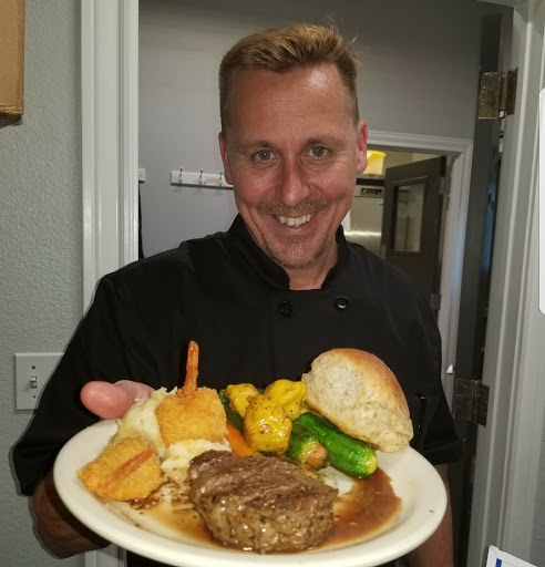 A chef proudly presenting a delicious meal.
