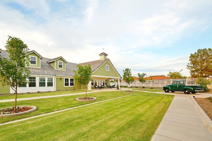 A suburban house with a well-maintained lawn and clear skies.