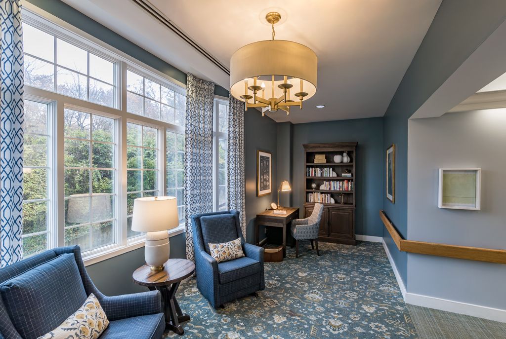 Cozy living space with blue chairs and a well-lit reading nook.