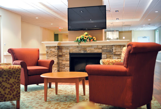 A cozy living room featuring comfortable seating, a fireplace, and a television.