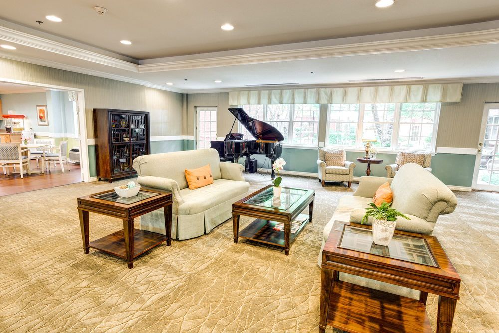 Spacious and elegantly furnished living room with a grand piano.