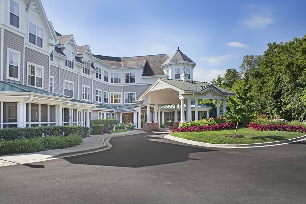 A large, elegant residential building with a welcoming entrance and landscaped surroundings.