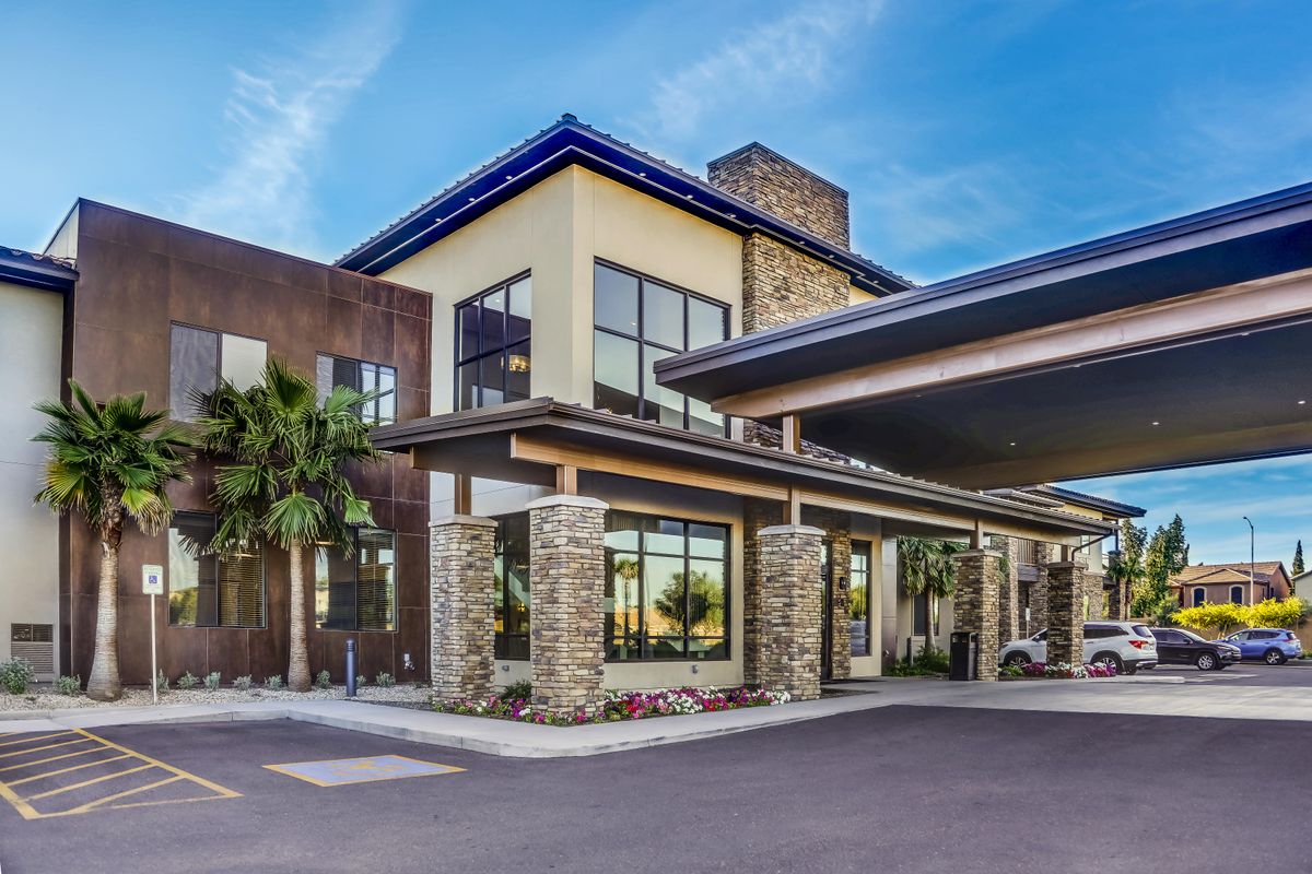 A modern hotel building with a stylish entrance and stone accents.