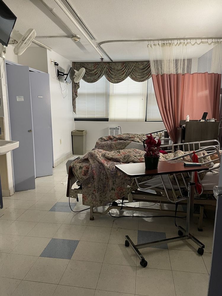 A hospital room with beds and medical equipment.