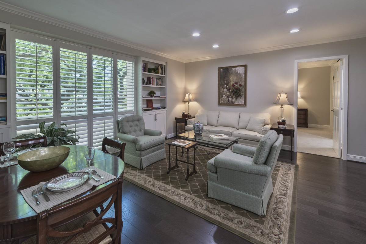 A cozy and elegantly furnished living room featuring a sofa, armchairs, a coffee table, and tasteful decor.