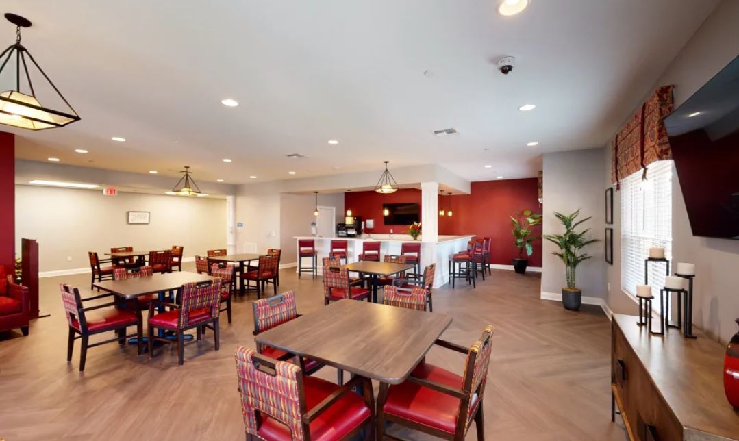 A modern dining area with tables and chairs arranged neatly in a spacious, well-lit interior.