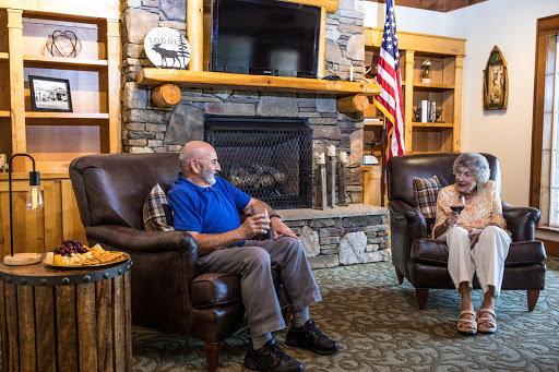 Two individuals enjoying a conversation in a cozy lounge setting.