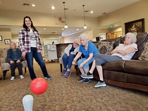 Seniors enjoying a fun bowling activity together in a community setting.