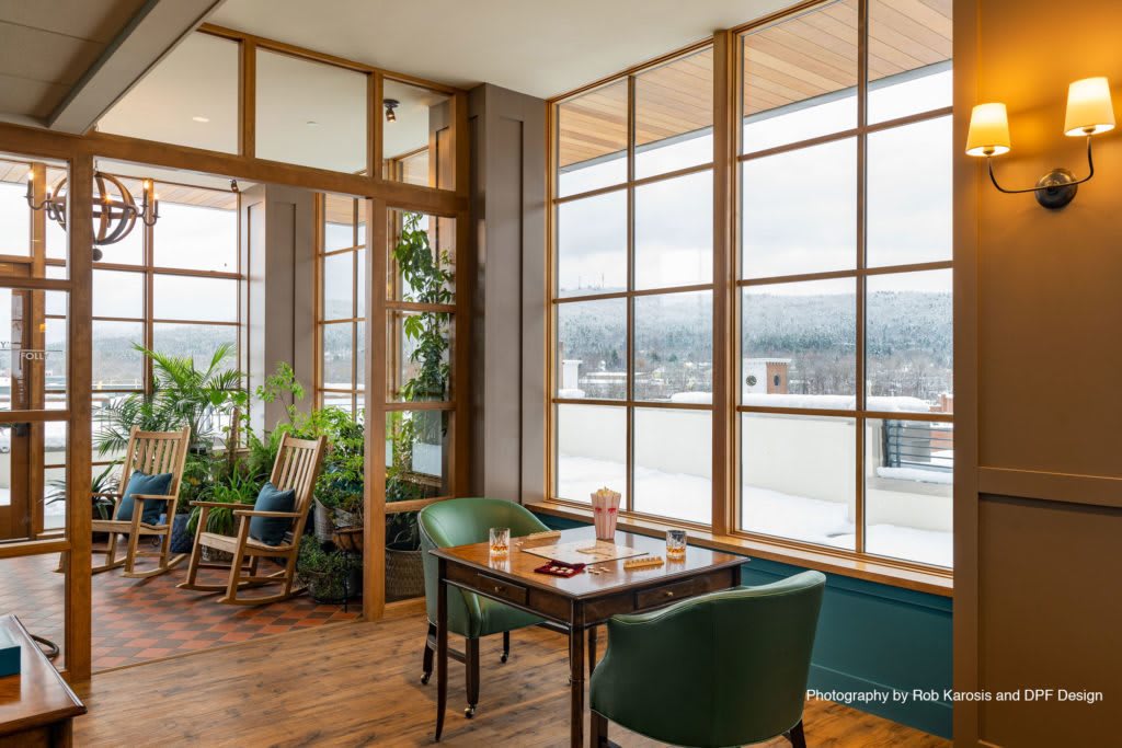Cozy dining area with large windows letting in natural light.