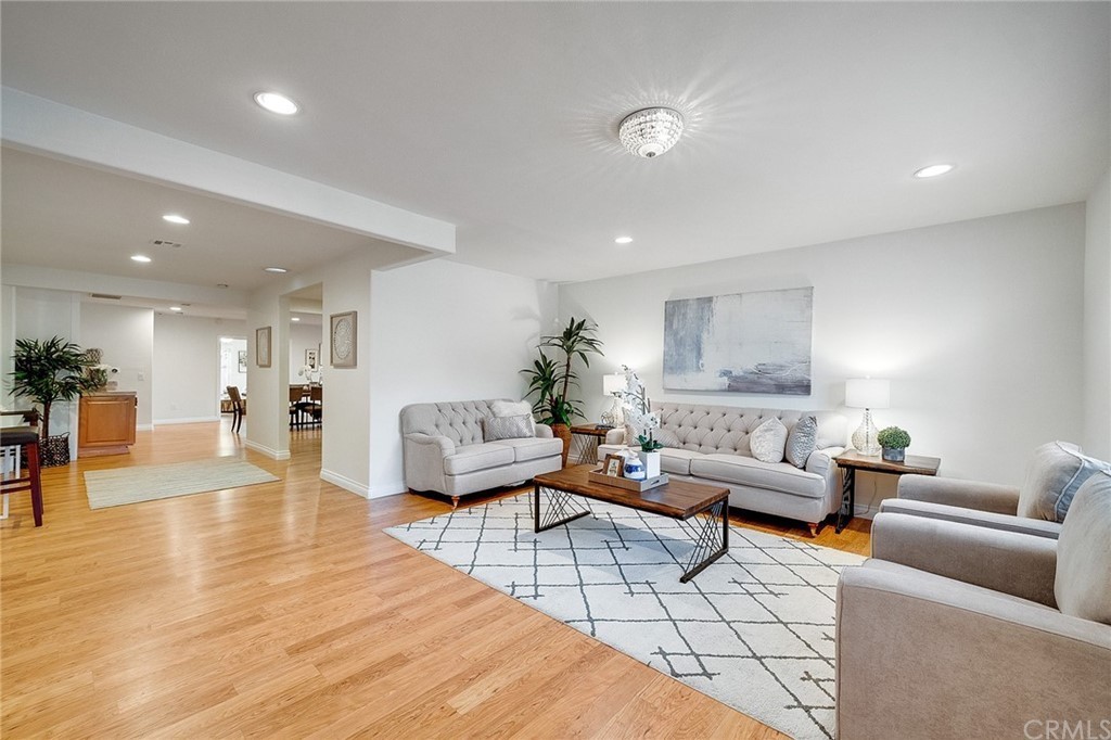 A modern living room with contemporary furnishings, featuring two sofas, a coffee table, and hardwood floors.