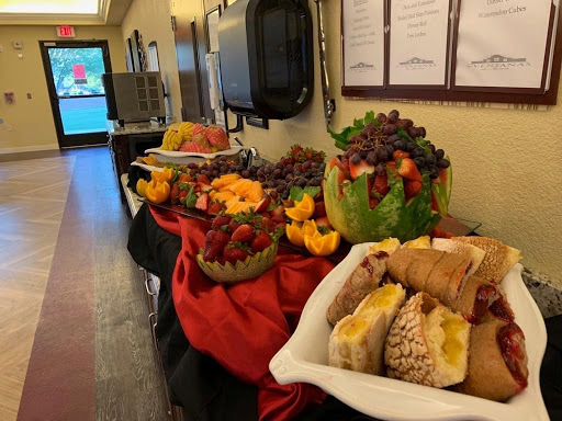 A vibrant display of fruits and desserts arranged for an event.