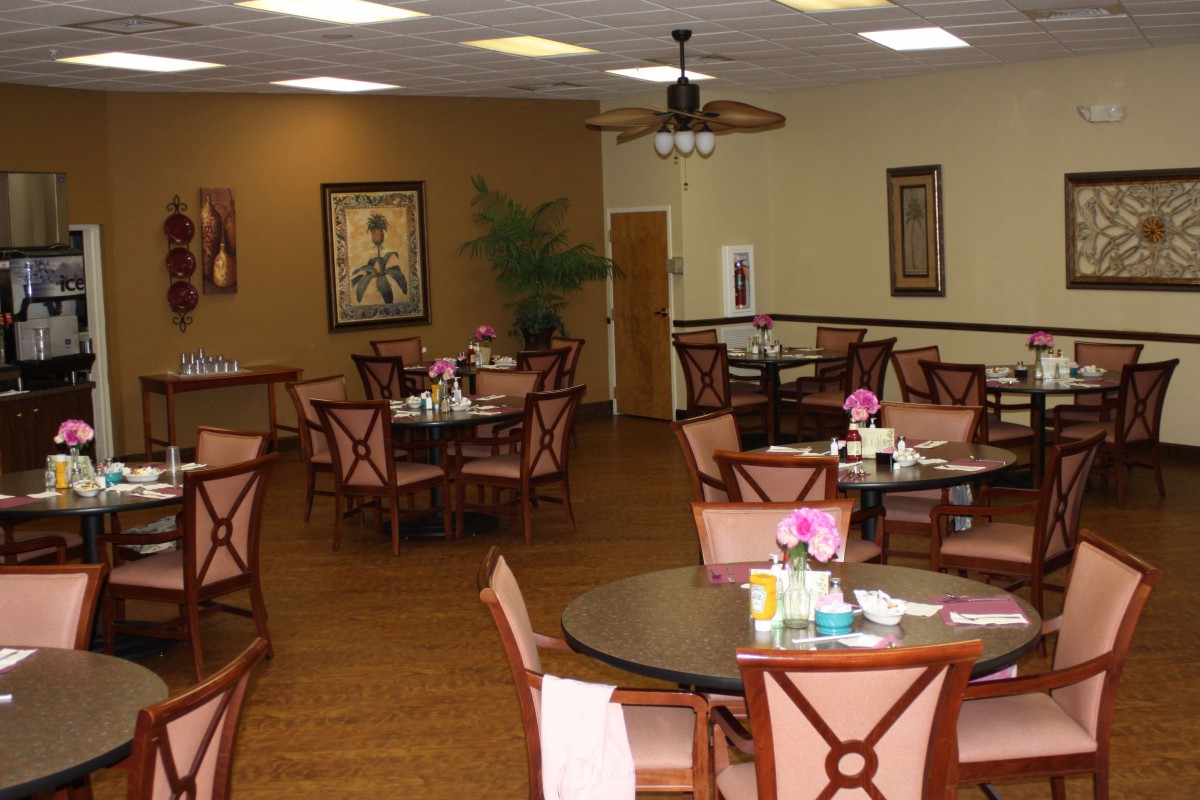 A cozy dining room with neatly arranged tables and chairs.