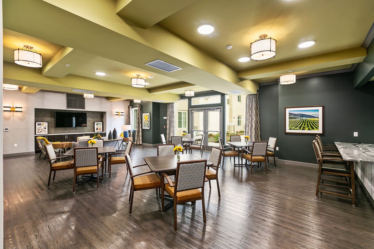 A modern dining area with elegant furnishings and ample lighting.