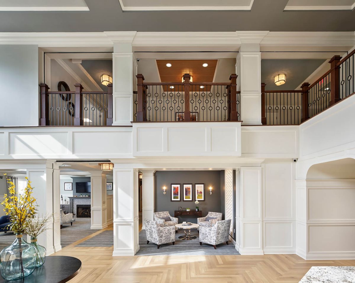 Luxurious two-story living room with elegant furnishings and sophisticated lighting.