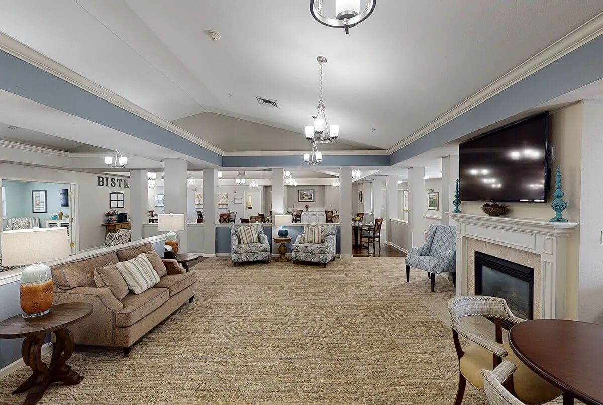 A cozy and elegantly furnished living room with a fireplace and comfortable seating.