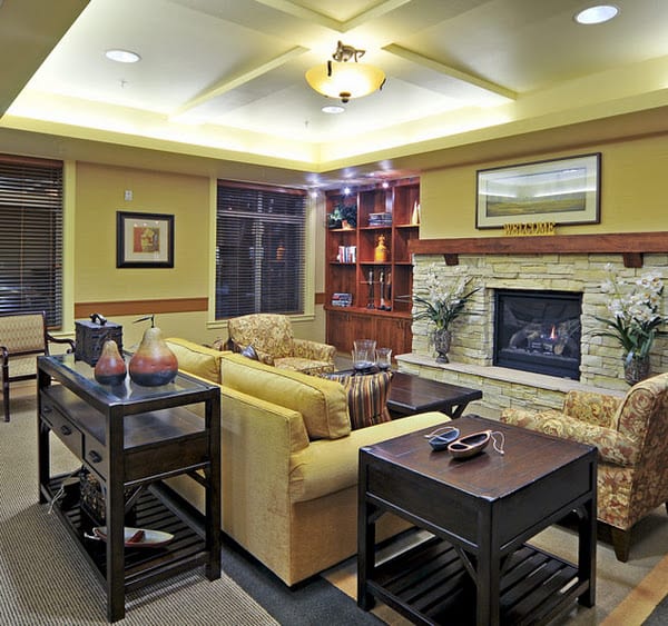 A cozy living room featuring a fireplace, plush seating, and elegant decor.