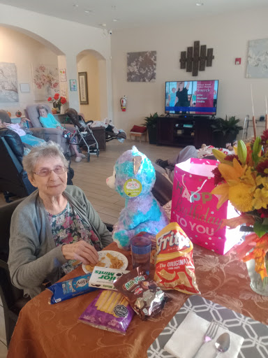A joyful moment shared with snacks and gifts in a cozy indoor setting.