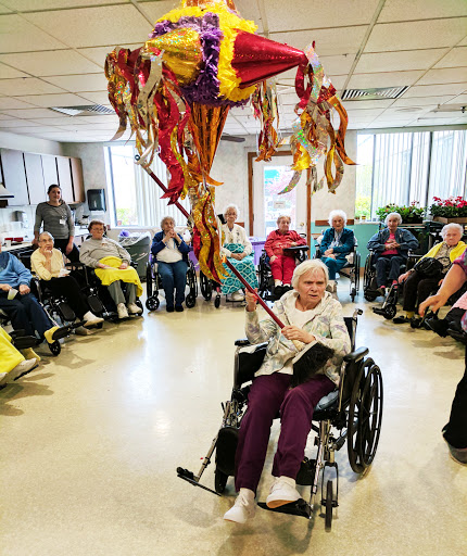 Residents gather for a joyful celebration, participating in activities and enjoying the festive atmosphere.