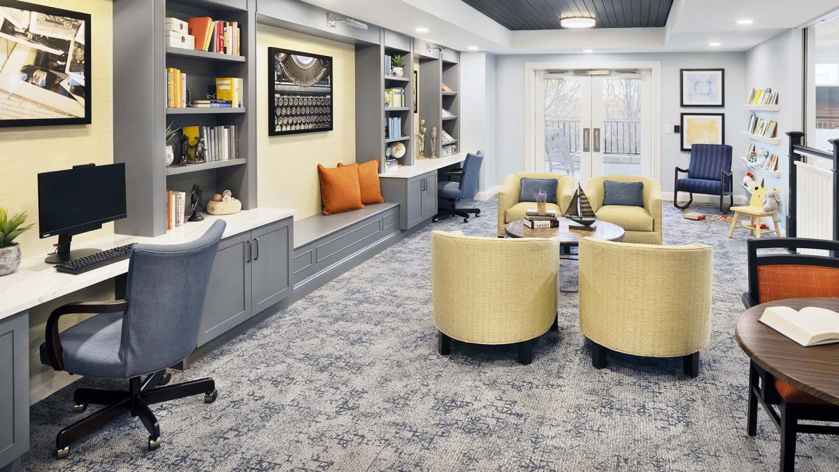 A modern living room interior with comfortable seating and built-in shelves.