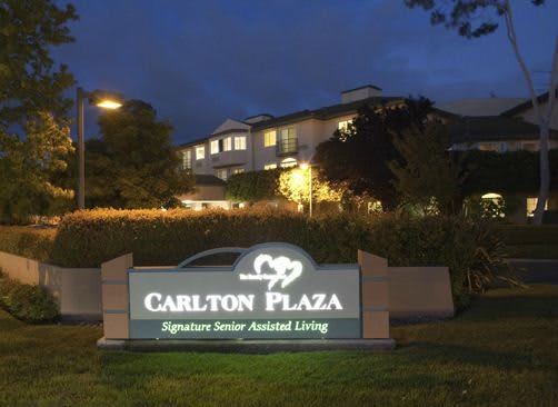 A nighttime view of Carlton Plaza, a signature senior assisted living facility.