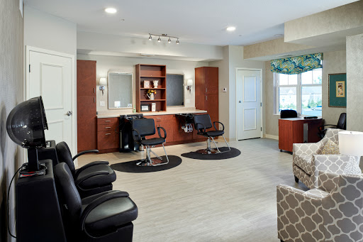 A modern hair salon featuring barber chairs, mirrors, and a welcoming waiting area.
