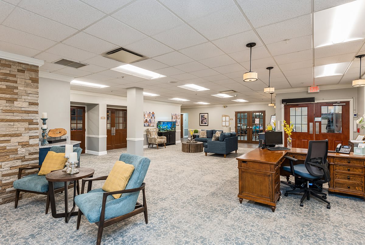 A spacious and well-decorated office lobby with seating areas and desks.
