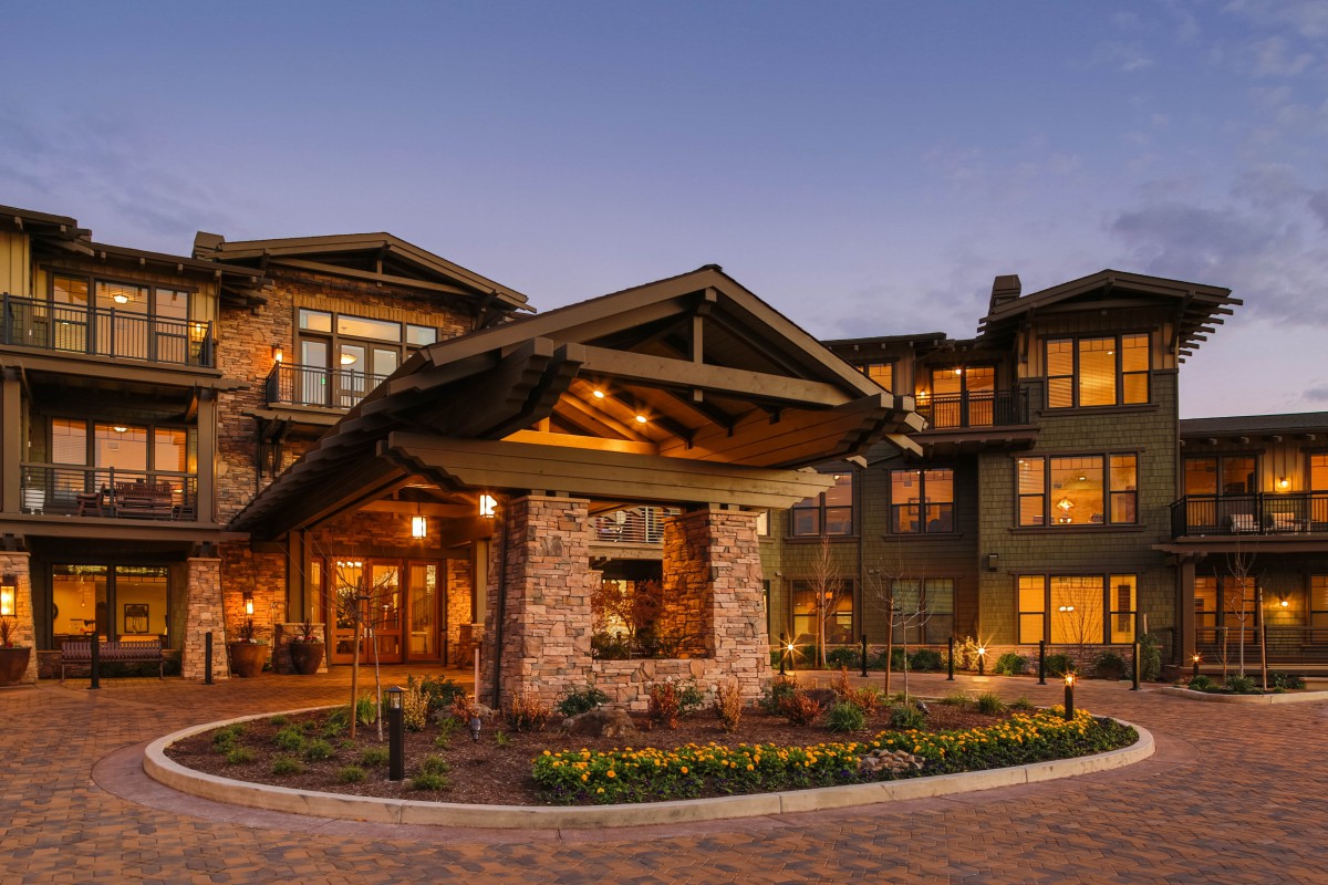 A beautifully lit house with charming architecture in the evening.