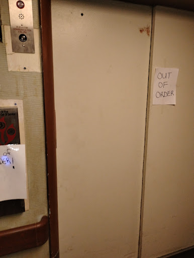 A door with a sign indicating that it is out of order.