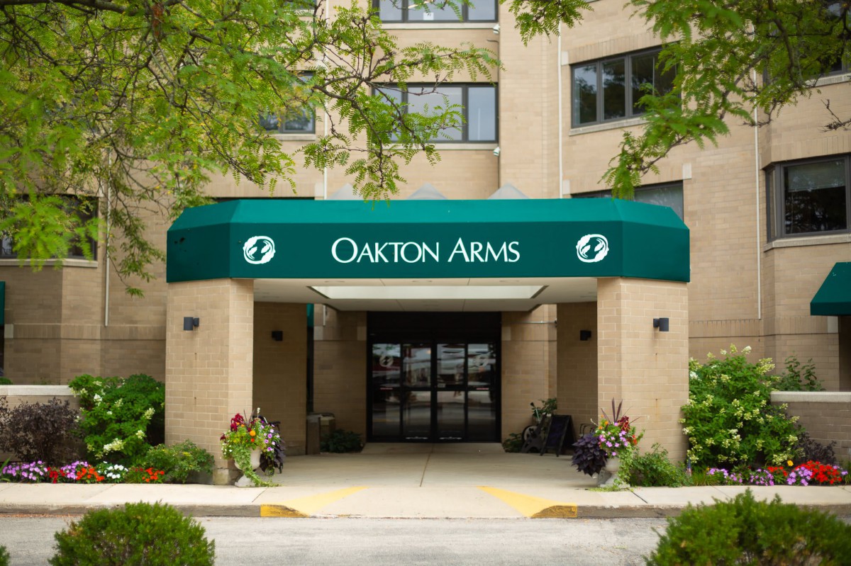 Entrance of a building with 'Oakton Arms' written on the green awning.