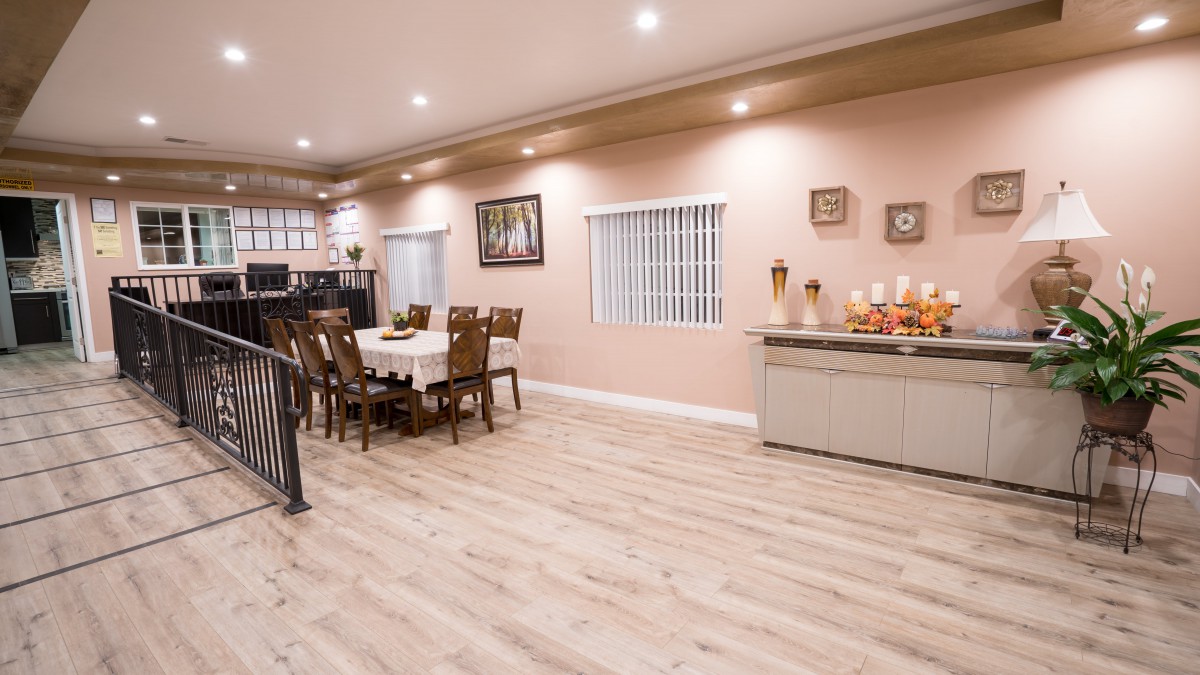 A spacious dining room with modern furnishings and warm lighting.
