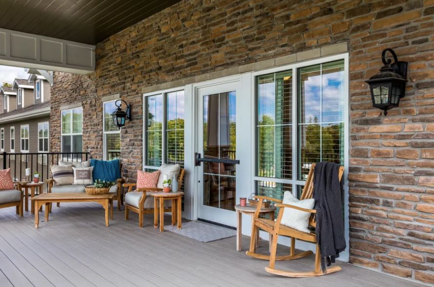 Cozy outdoor patio with rocking chairs and stylish decor.
