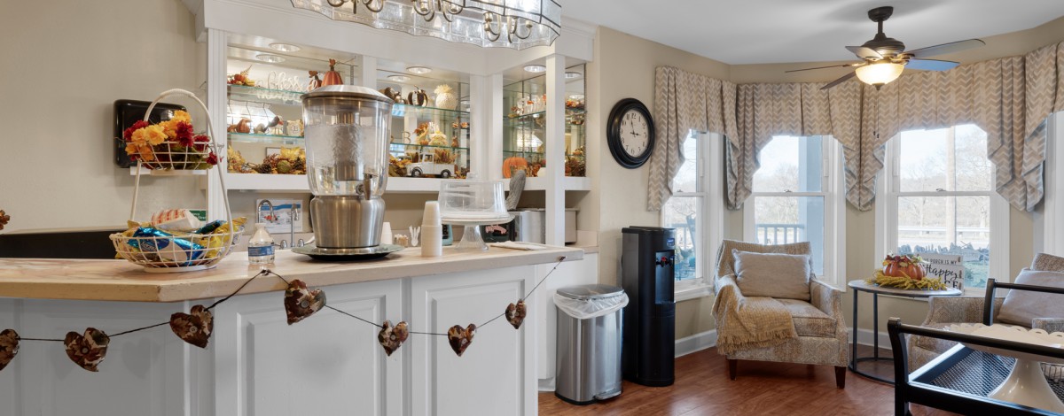 Cozy kitchen interior with a coffee station, mirror backdrop, and decorative elements.